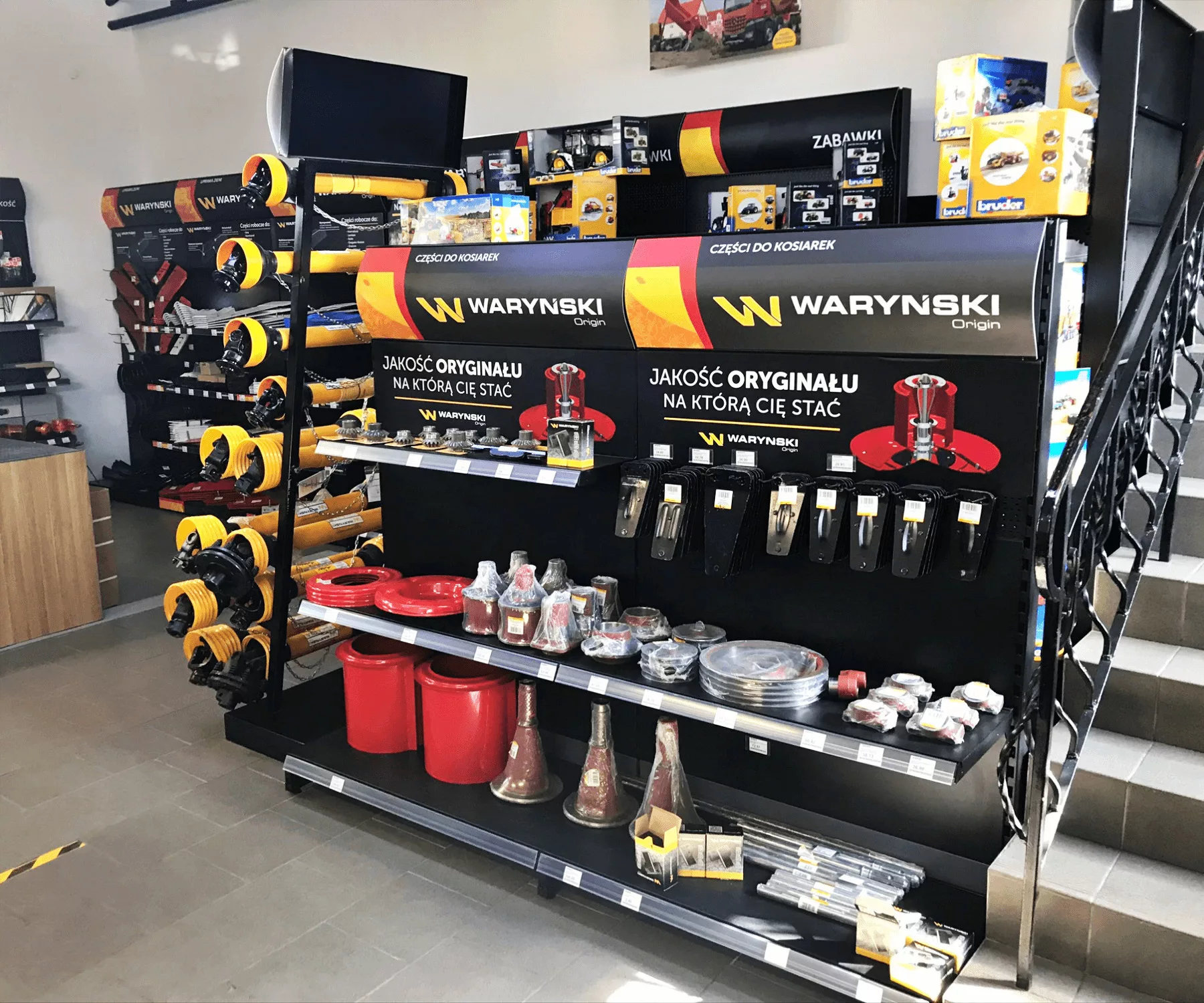 Interior of a professional turbocharger repair workshop showing organized workstations with red tool cabinets, specialized equipment and various turbocharger parts on display